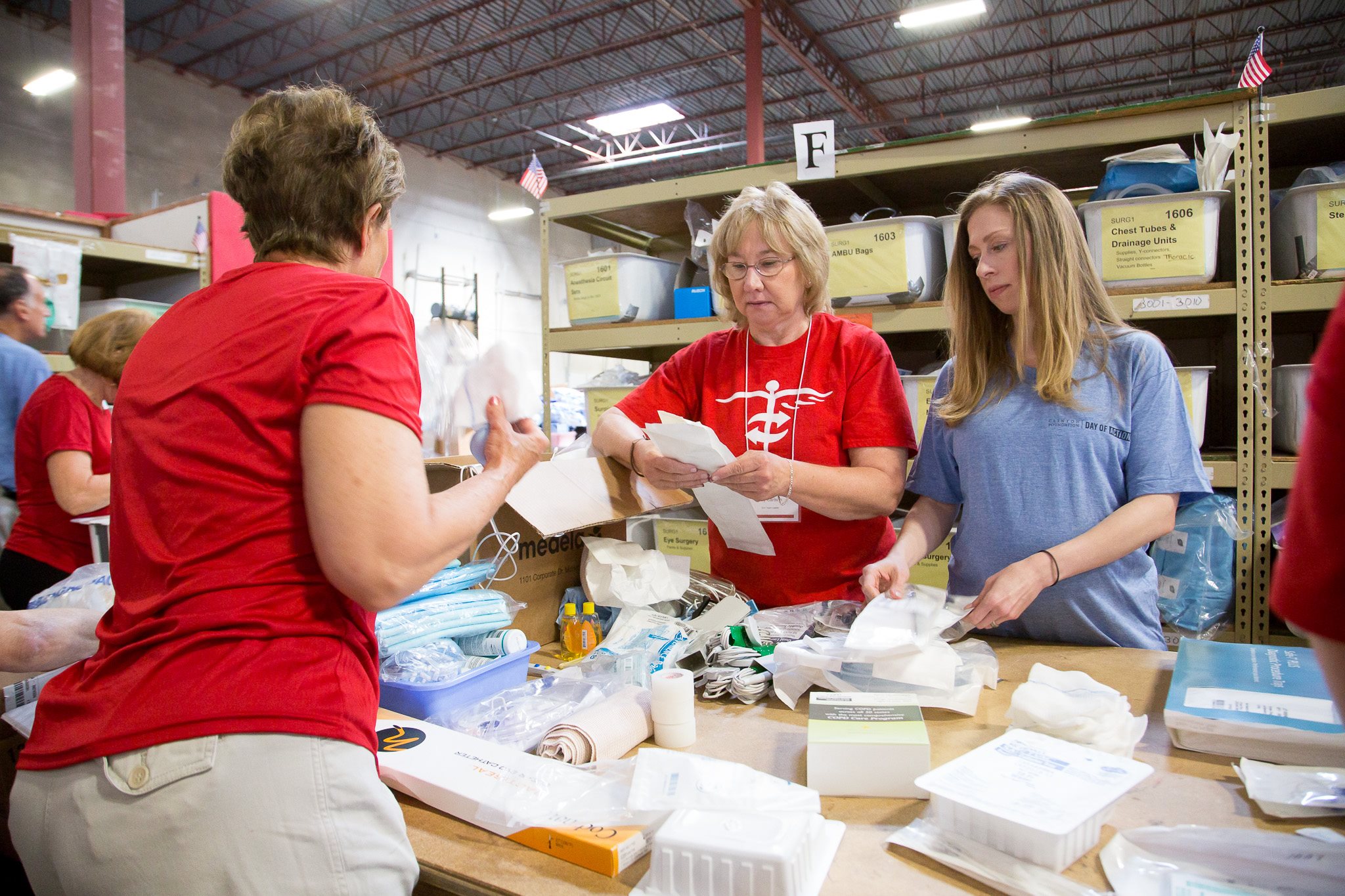 individual volunteers sort medical supplies for medical relief boxes