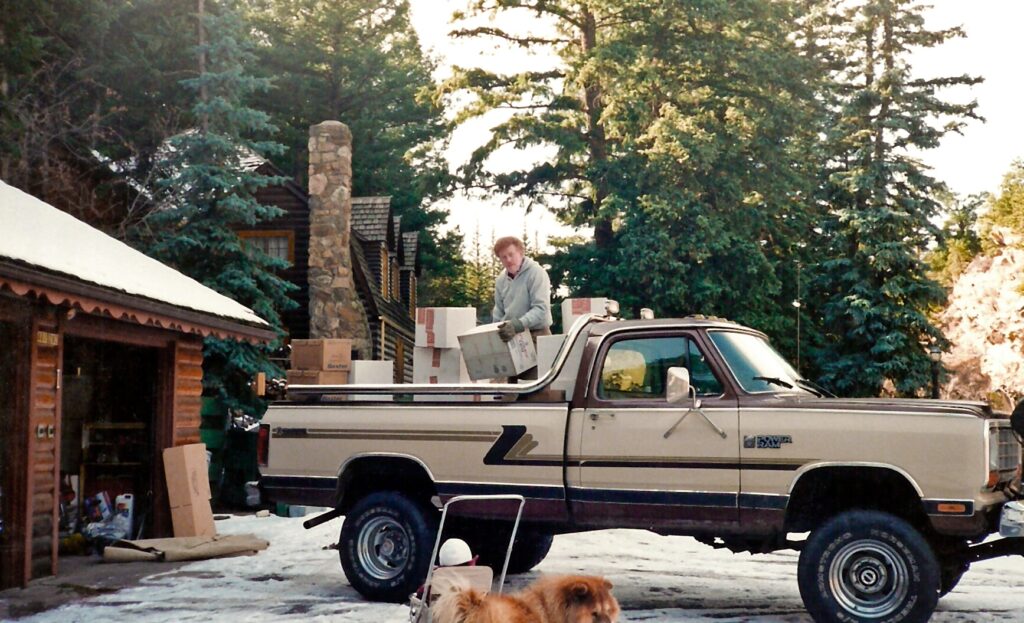 Historic photo of man with boxes of donated medical supplies in the back of his Ram Truck. 