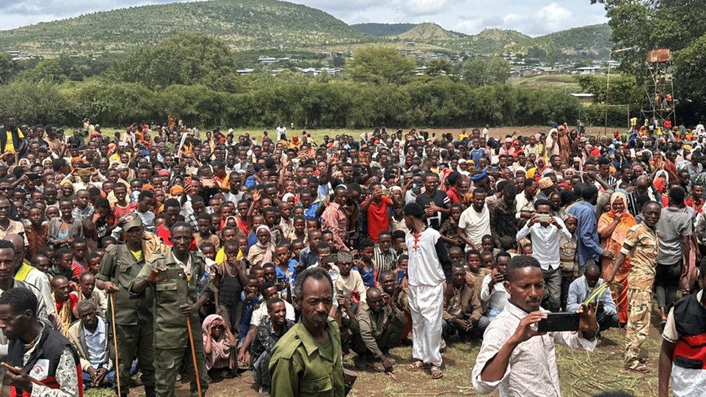 Group of people from Oromia gathered in a field to welcome and thank Project C.U.R.E.