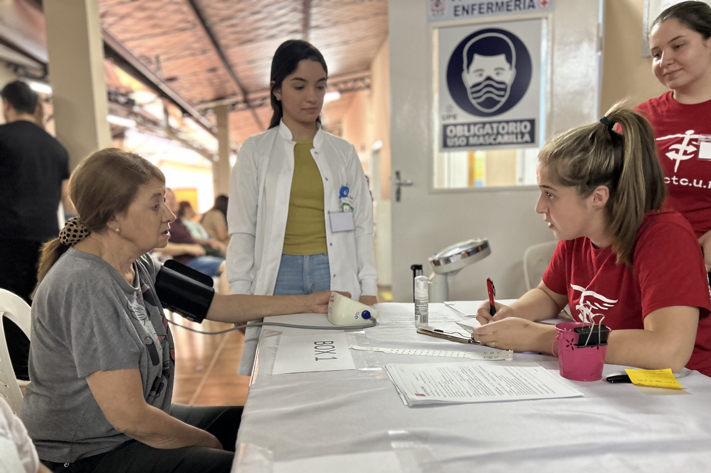 Medical mission trip volunteers from Project Cure gather info and vitals from a cervical cancer screening patient in Paraguay