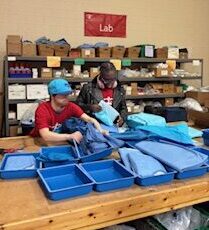 Hinsdale transition students volunteering in Chicago warehouse sorting medical supplies
