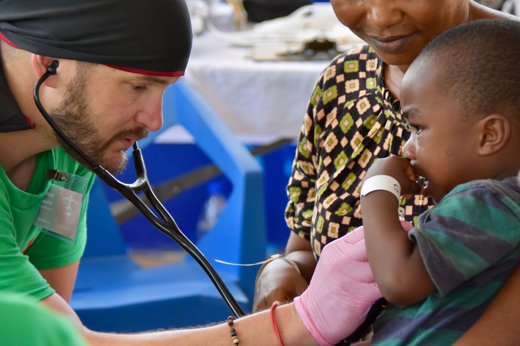 Matthew Johnson, medical volunteer, assesses a patient in Cote d'Ivoire, Africa for Project CURE and global impact of healthcare