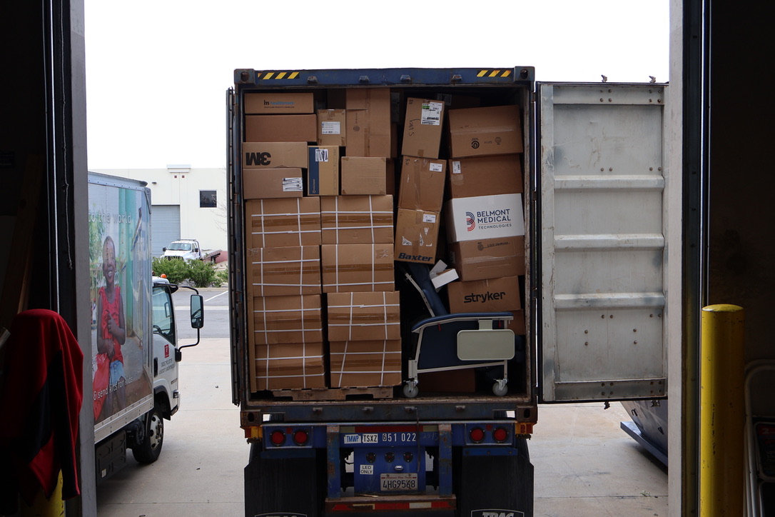 Fully loaded C.U.R.E. Cargo container packed with donated medical supplies, including boxes labeled Stryker, Belmont Medical, and 3M, ready for global shipment from a Project C.U.R.E. warehouse.
