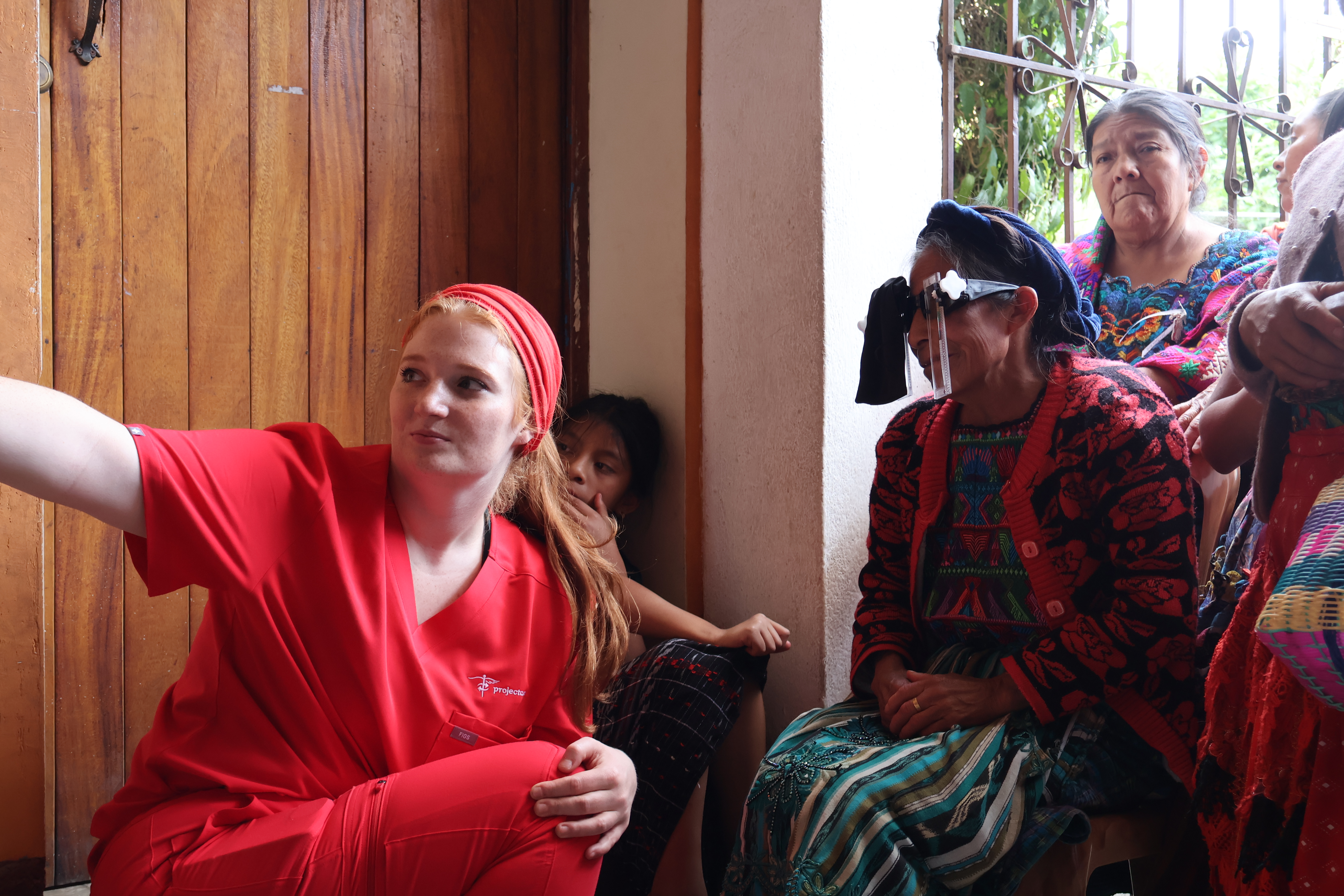 Indigenous Guatemalan woman weaver is undergoing an eye exam at a rural vision clinic to preserve her livelihood.