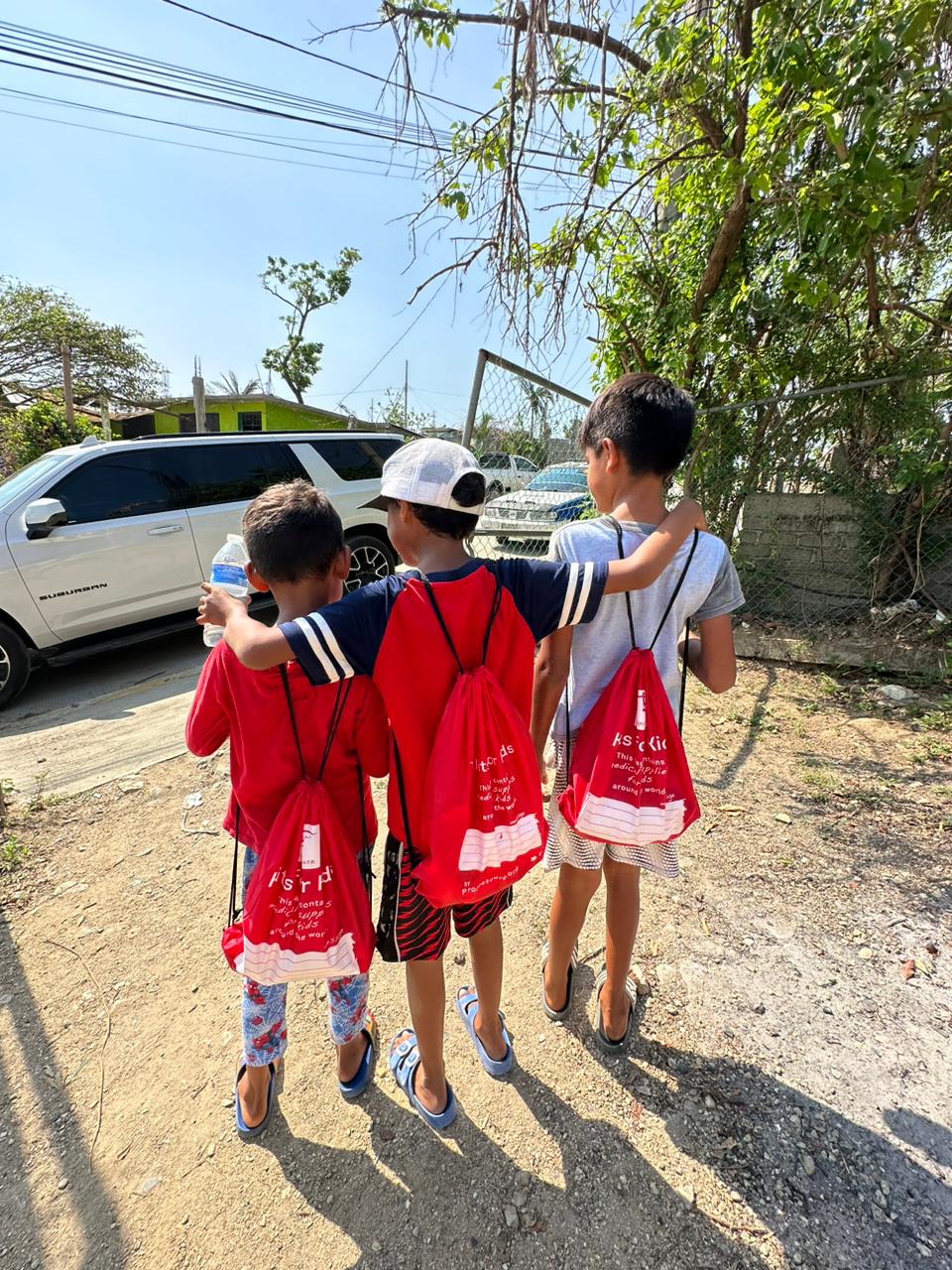 Three boys in Acapulco with their Kits for Kids backpacks