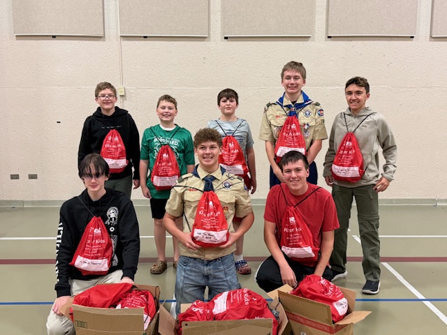 Tyler and other Eagle Scouts volunteering with Project C.U.R.E., packing Kits for Kids.