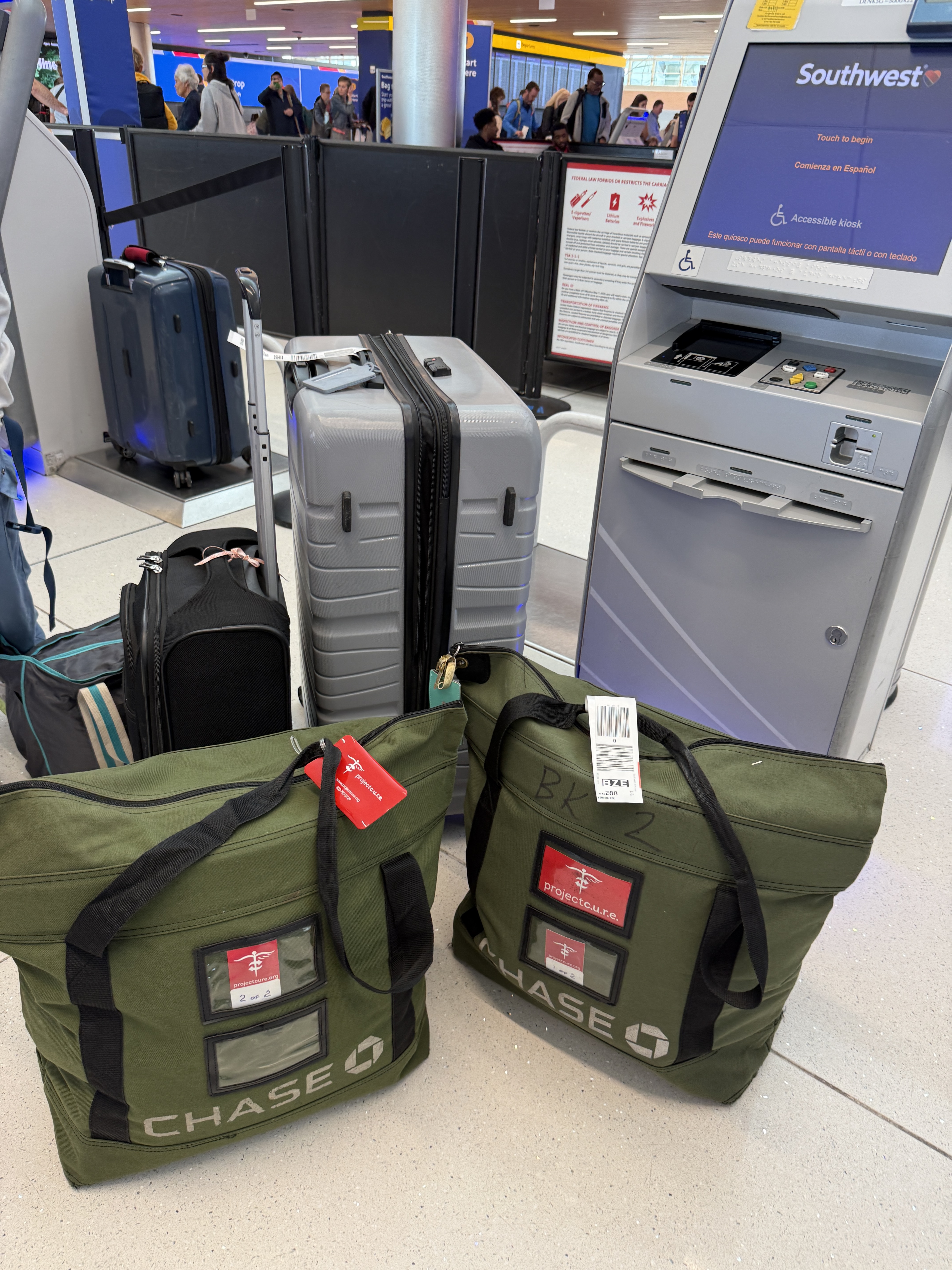 C.U.R.E. Kits being checked onto the airplane at a United bag check