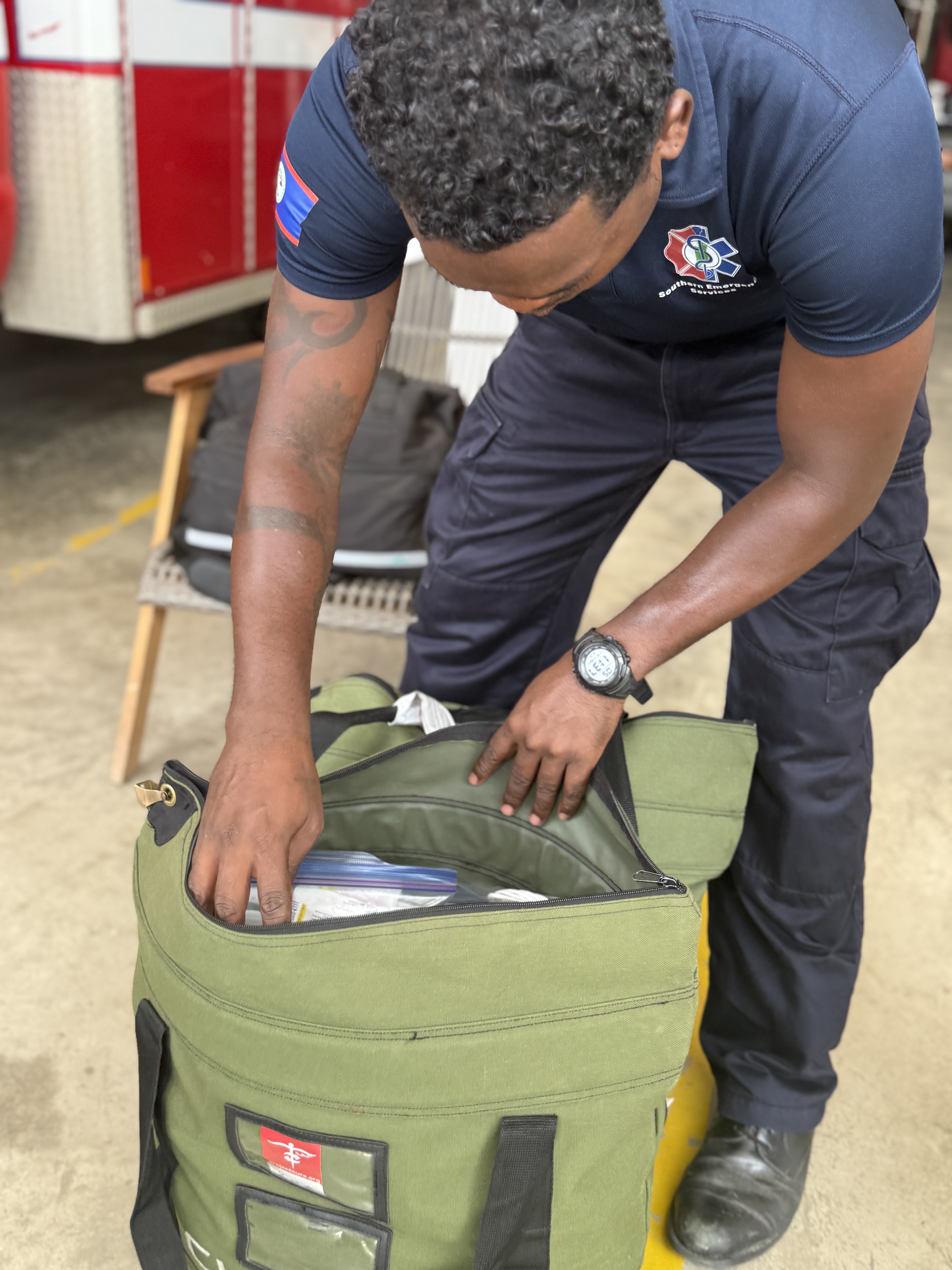 Local EMT in Belize opening a donated C.U.R.E. Kit
