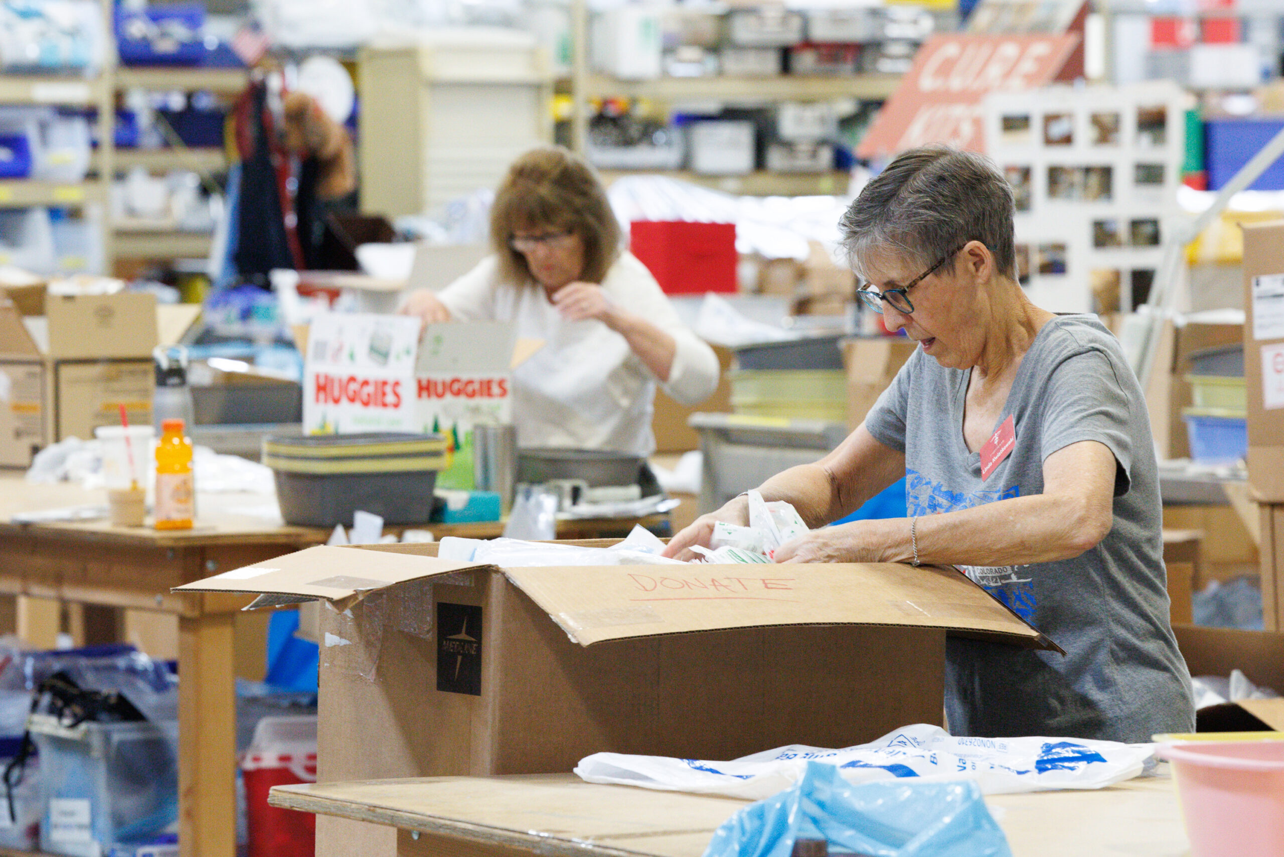 Project C.U.R.E. volunteers packing donated medical supplies